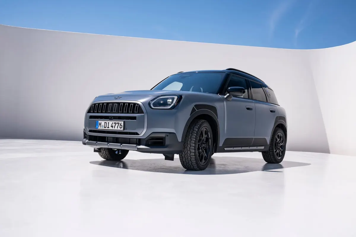 MINI Countryman Untamed Edition серо-голубого цвета спереди в три четверти на фоне белых стен студии