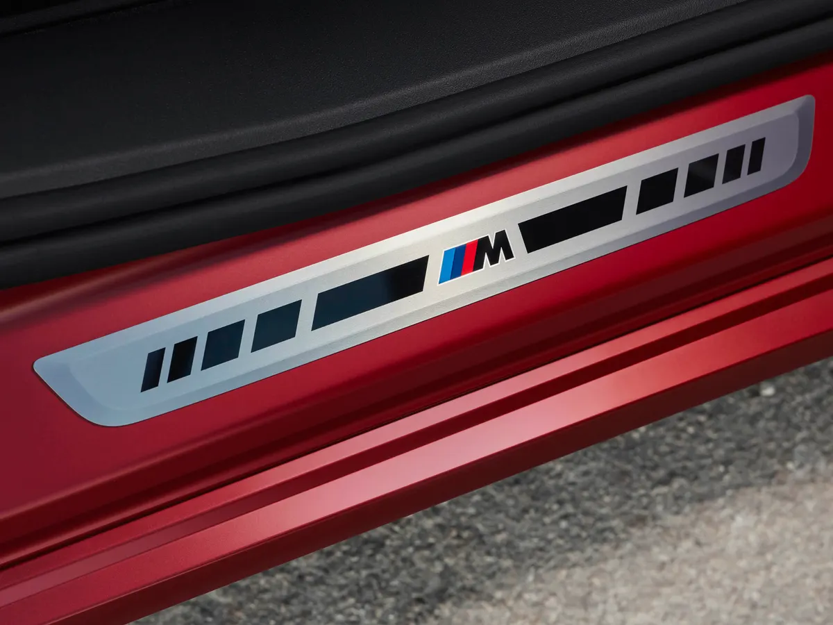 Накладка на порог с логотипом M на красном кузове BMW iX4