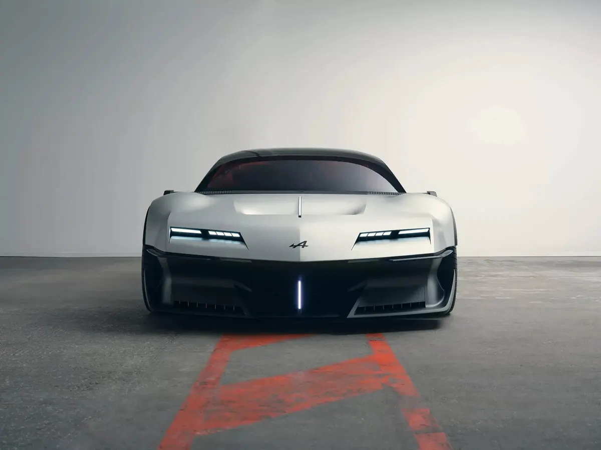Концепт Alpine A310 VISION строго спереди: узкие светодиодные фары и вертикальная полоса света в бампере