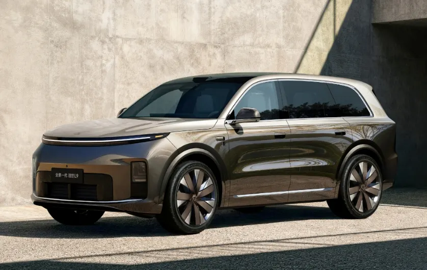 Новый Li Auto L9 в бронзово-золотистом цвете с тонкой световой полосой на капоте у бетонной стены