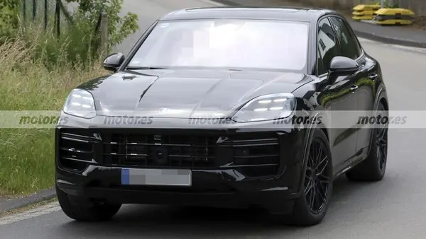 Чёрный Porsche Cayenne Turbo E-Hybrid в кузове купе, вид спереди: диски тёмного цвета, на бампере размытый номер