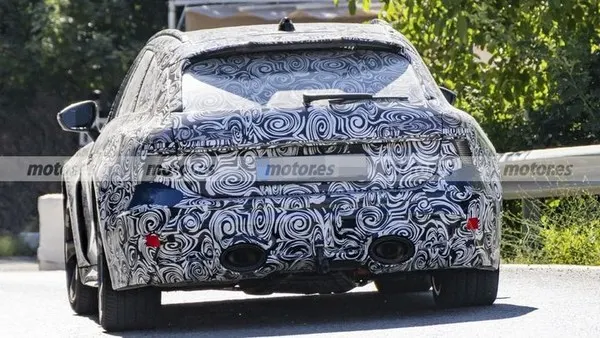 Прототип Audi RS 6 Avant в камуфляже сзади: спойлер на крыше, два овальных выхлопных патрубка, красные отражатели